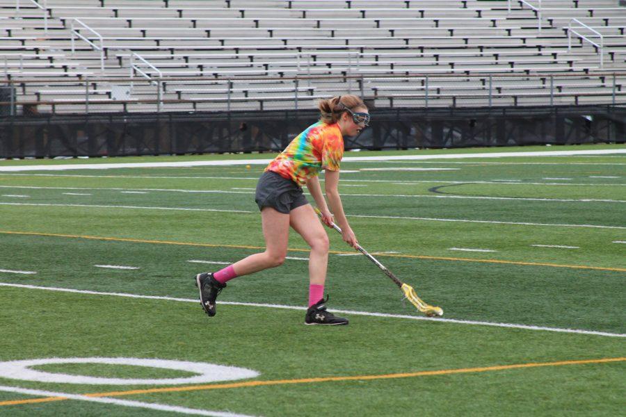 Maddie McCahill 17 runs after a ground ball at lacrosse practice. 