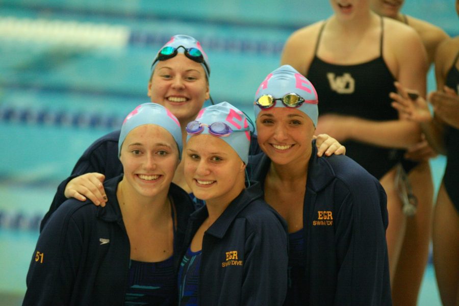 Kennzie Hartmann 18, Sydney Higgins 19, Lainey Skaggs 18, and Ashley Ward 18  atop the podium at West Michigan Relays for their second place 400 Medley relay finish. 