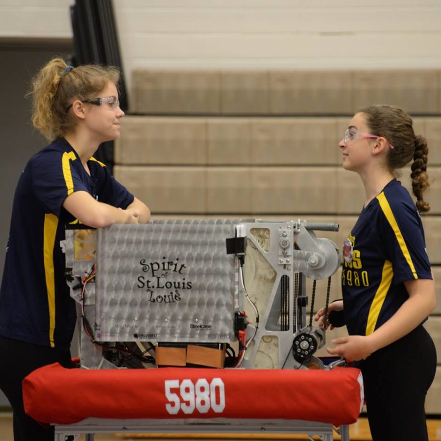 Clara Luce and Carlie Couzens 18 wait with their robot in the loading area before a match.