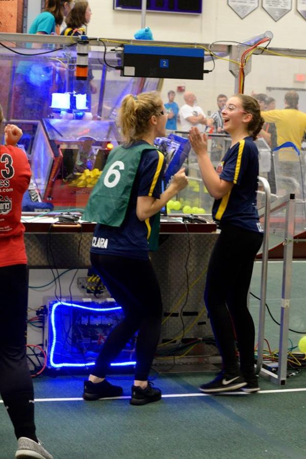 Clara Luce 18 and Carlie Couzens 18 share a lighthearted moment before driving the robot in the quarterfinal matches.