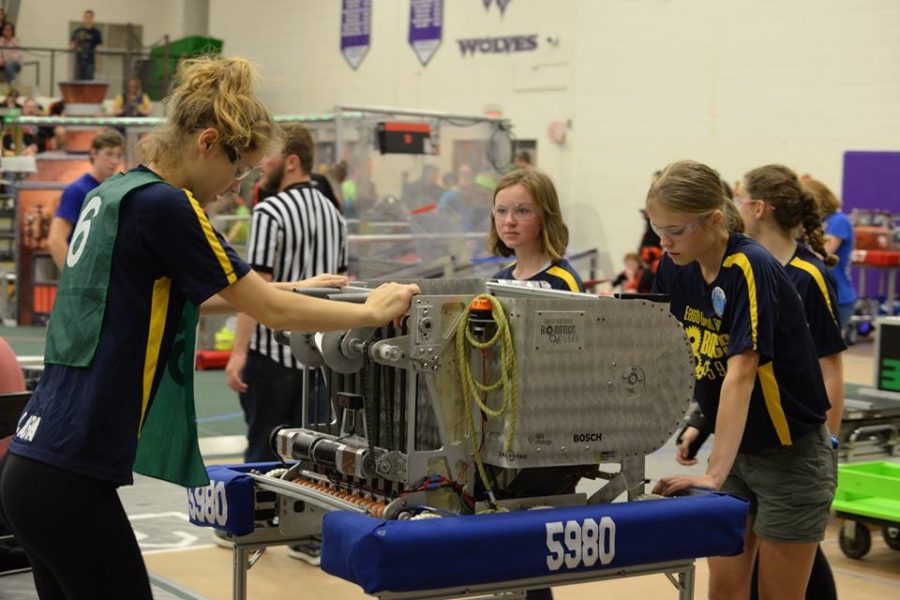 Clara Luce 18 and Lauren Vanden Bosch 19 silently contemplate the robot while waiting in line for another match to begin.