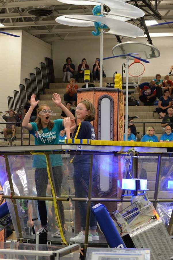 Libby Chambers 21 glances at the winning score before high fiving a girl from another team on frc 5980s alliance.