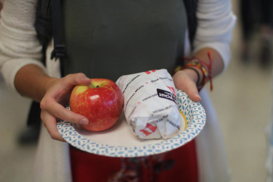 One student chooses an apple and Jimmy Johns sandwich for their lunch.