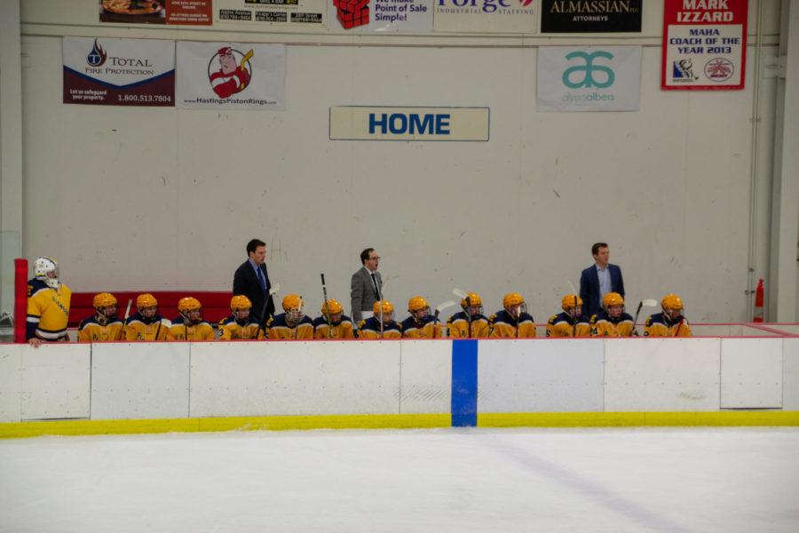 The hockey team believes they can take home a state championship this year. Here they sit on the bench outside the ice rink.