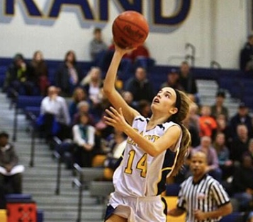 Mary Schumar 19 shooting a basket on her home court.