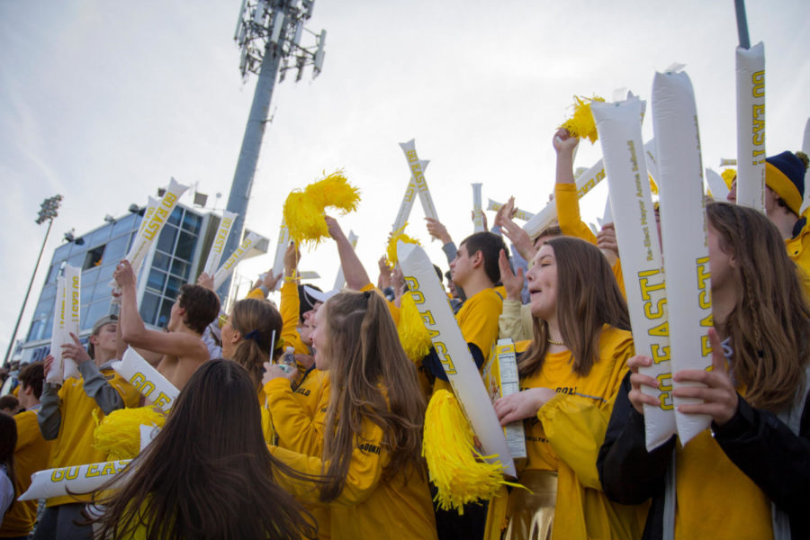 Students cheer for football team at the Hearts of Gold event.