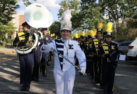 Drum Major Rotem Andegeko 22 leads the marching band to the field. 